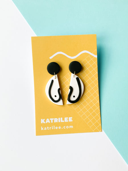 The Mammarlee Half Circle Dangle Boob Earrings - Black and White - Katrilee